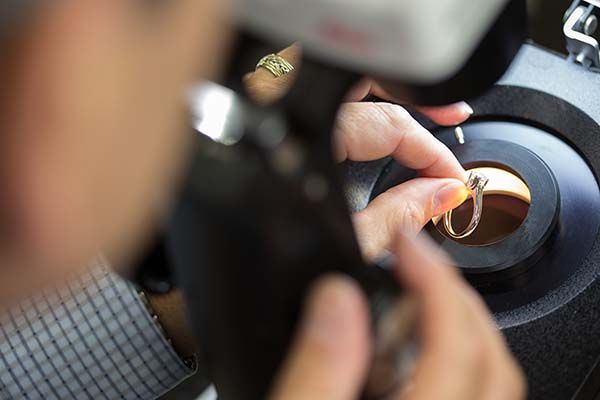 Jewelry being inspected and reconditioned under a microscope